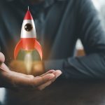 Businessman holding a rocket